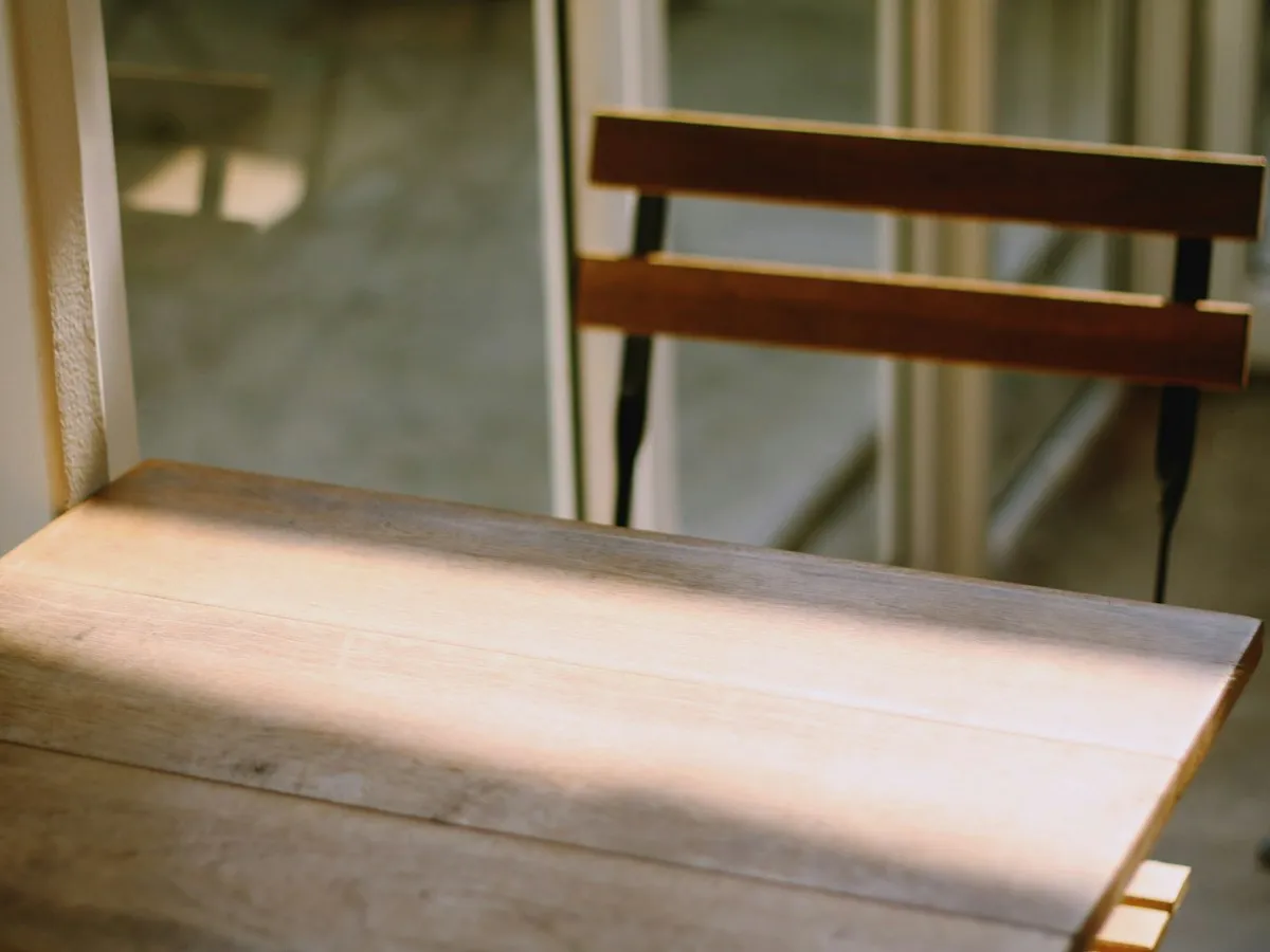 Natural light across a wooden desk and chair