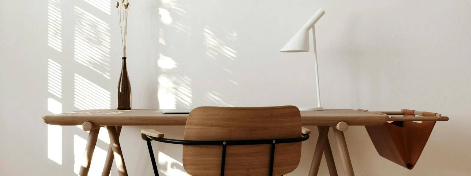 A warm, naturally lit wooden table and chairs
